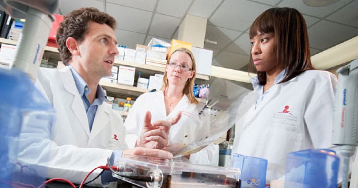 Dr. Mullighan with two researchers