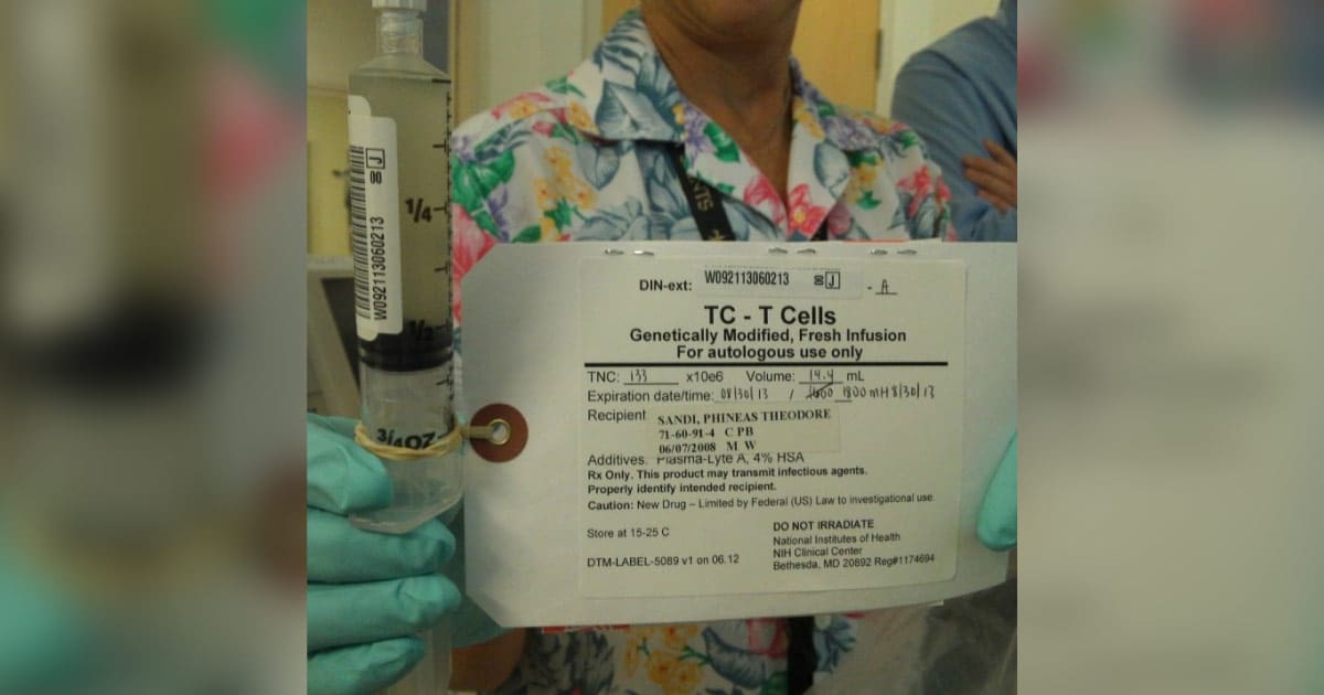 A nurse holds the single syringe of modified T cells used during Phineas's immunotherapy