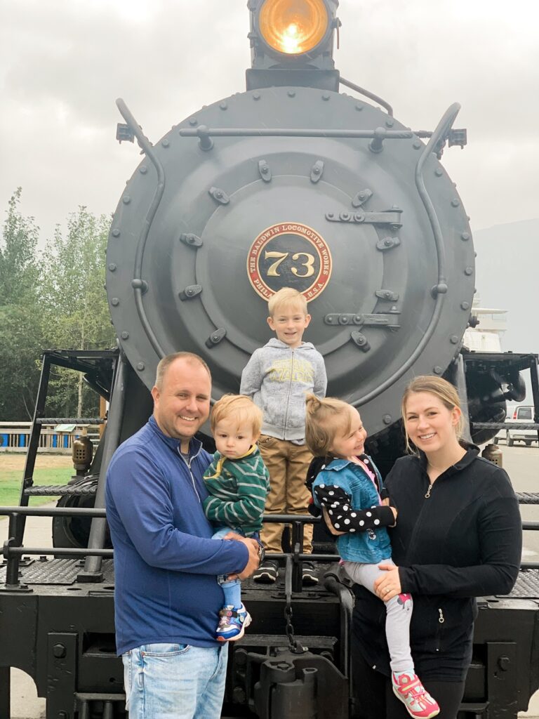 Danica with her mom, dad, and brothers in front of a train