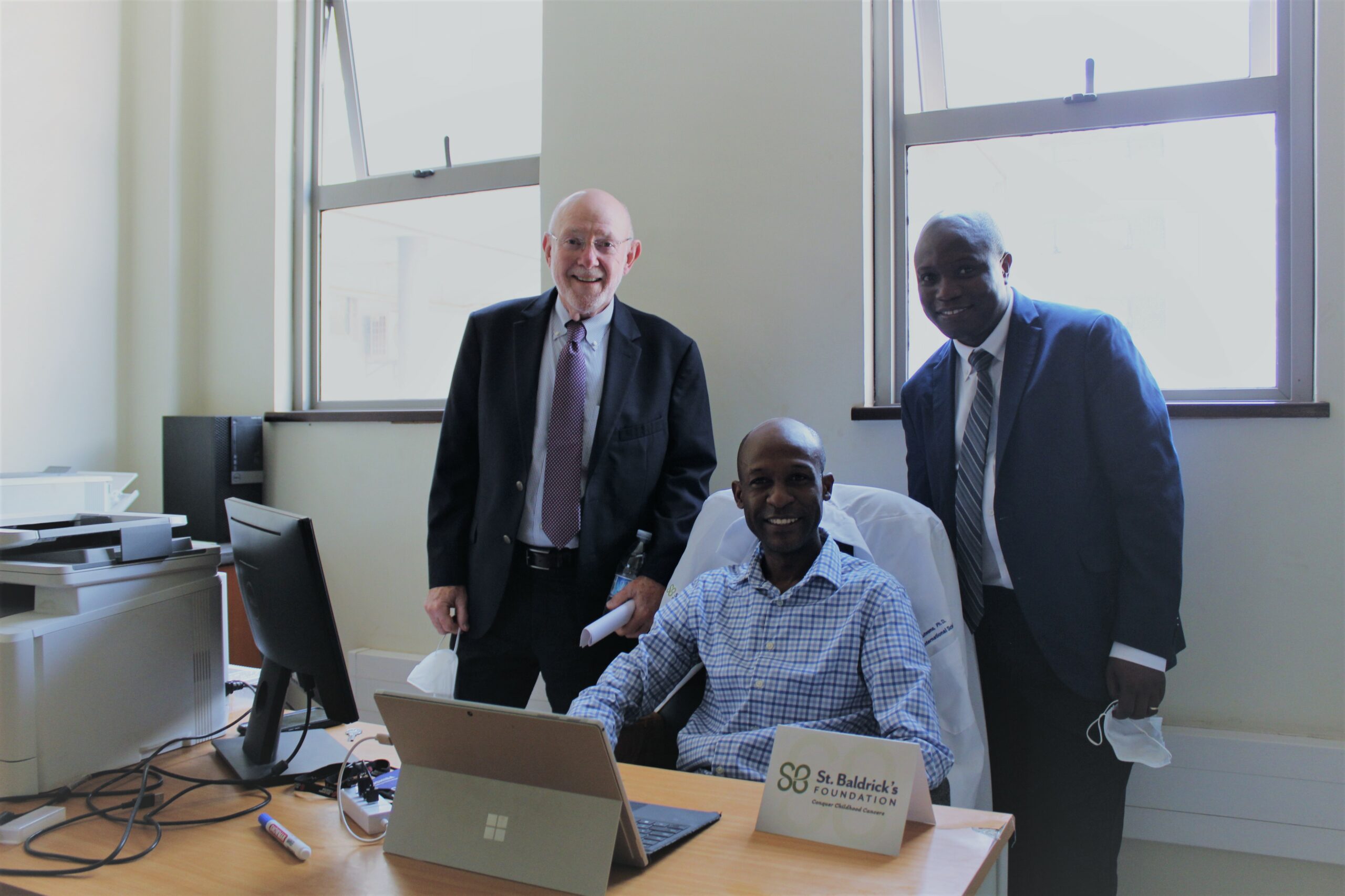 Dr. Fred Lutwama, current St. Baldrick’s International Scholar (center) with Dr. David Poplack (left), and Dr. Joseph Lubega (right)