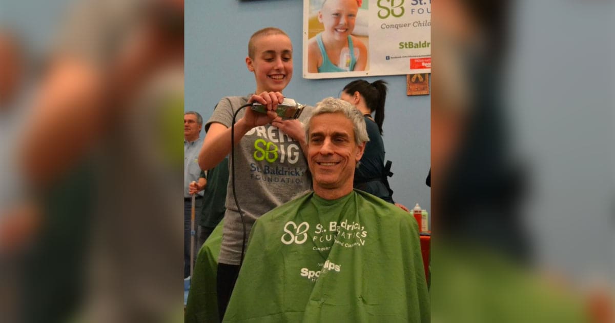 Greta shaving her dad’s head at 2016 St. Baldrick’s event