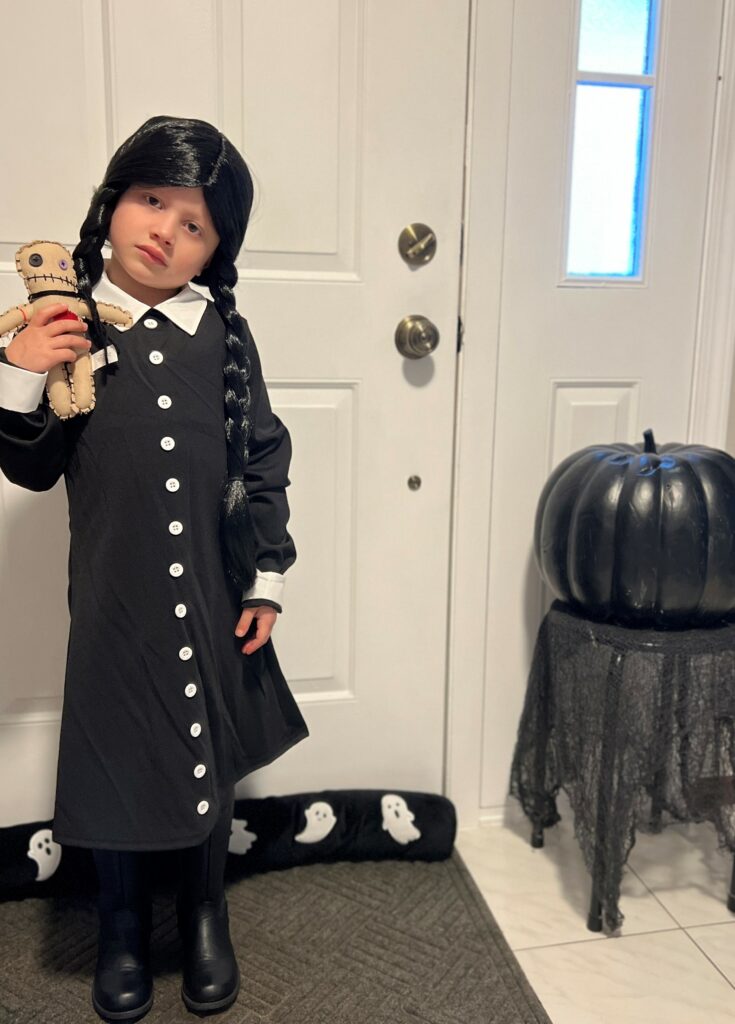 Mia dressed as Wednesday Addams for Halloween.