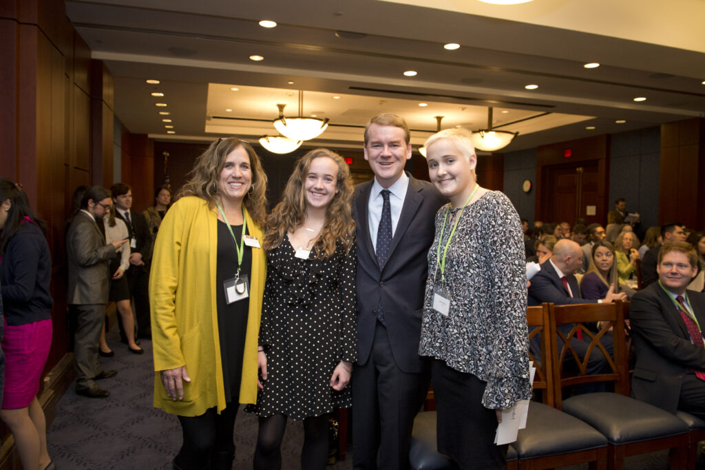 Martha with her mom, Margaret, twin sister, Annie, and Colorado Senator Michael Bennet