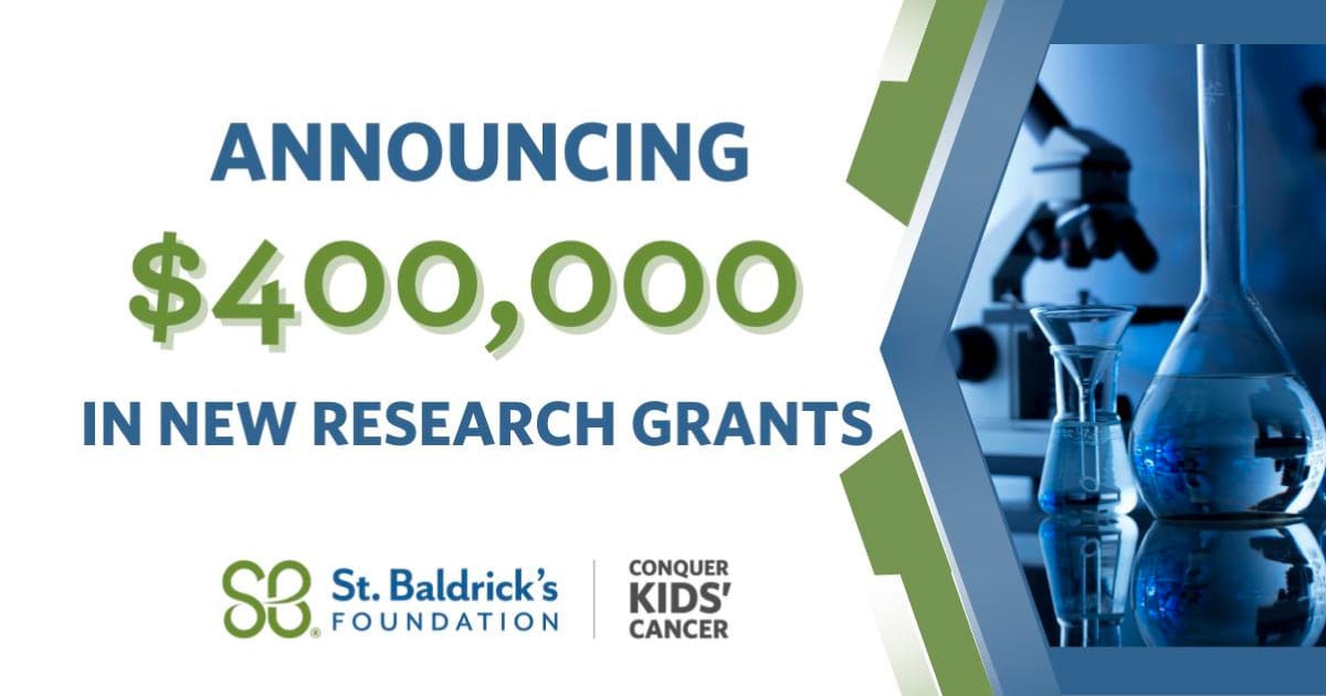 Announcing $400,000 in new research grants next to science laboratory equipment