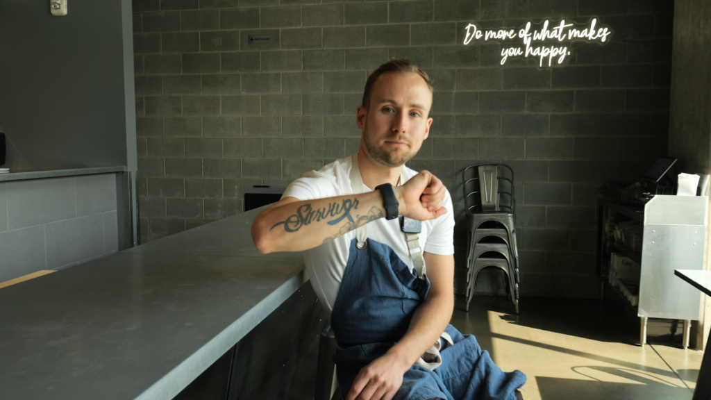 cancer survivor Connor Johnson showing his cancer survivor arm tattoo