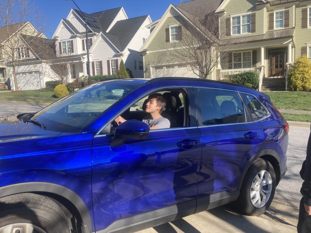 cancer warrior Scott in a blue car on a driveway