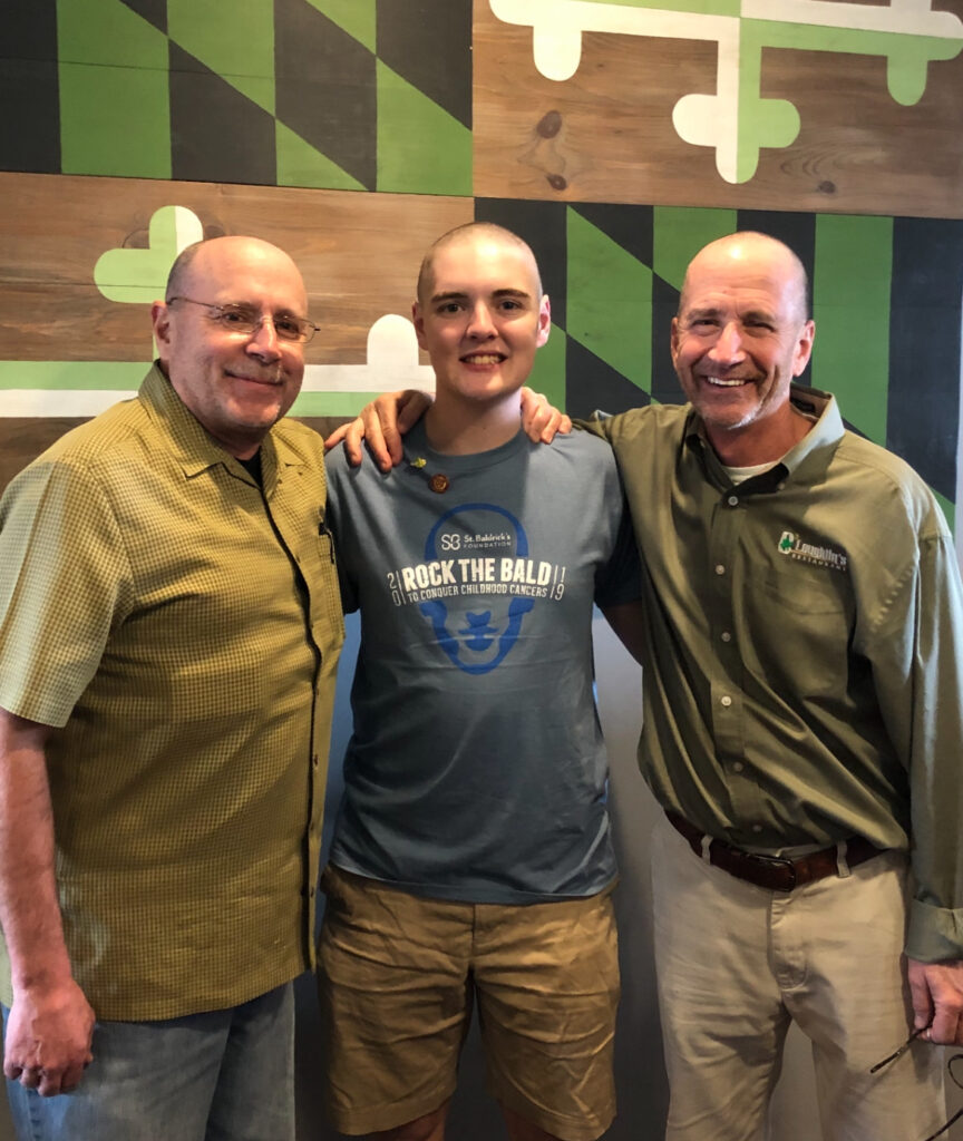 Billy (middle) at the 2019 Annual Brave the Shave In Memory of Joey Sudo Event with Tom Suit (left in a short sleeve shirt) and Tom Crawford (right in a long sleeve shirt).