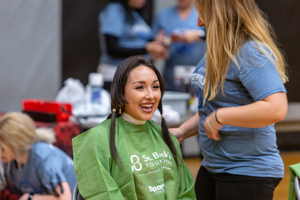 a female shavee getting ready to cut her hair off for hair donations