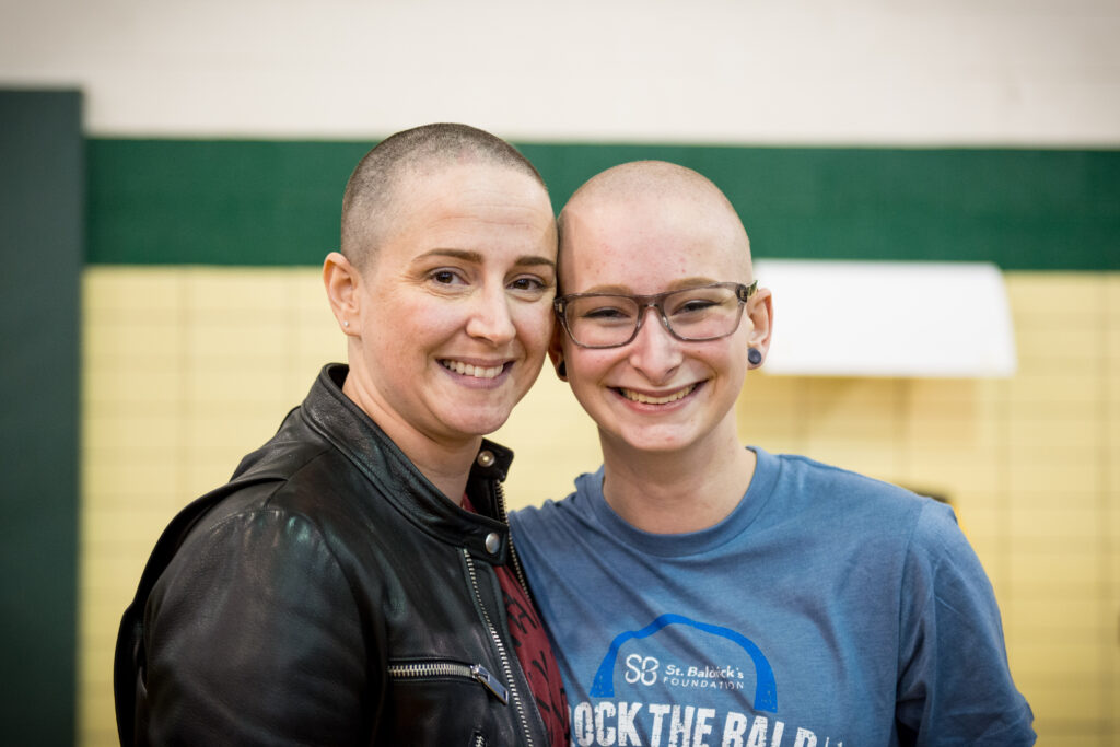2 female shavees with smiles while rocking the bald