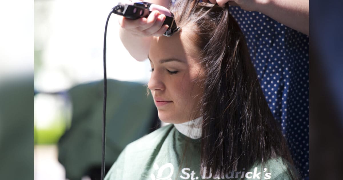 a female shavee getting her long locks shaved off for charity