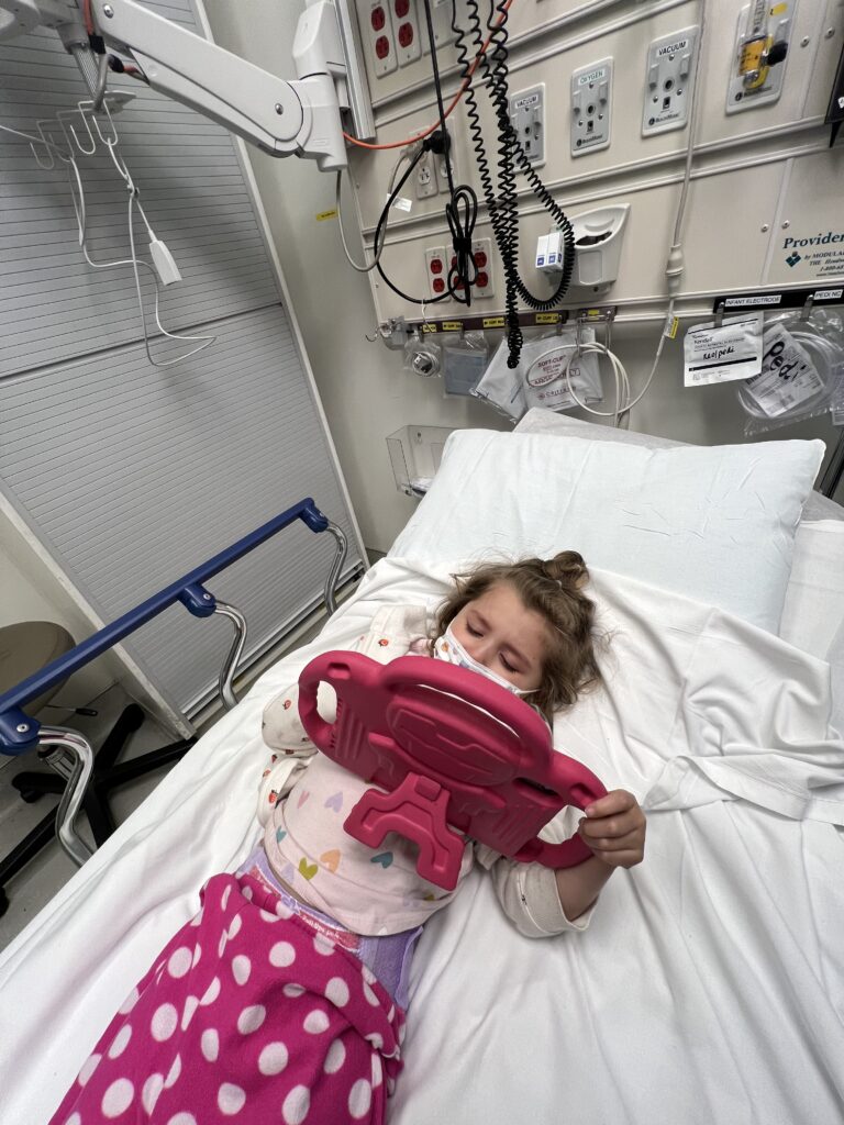 cancer warrior Vera playing on her iPad in a bed in the emergency department
