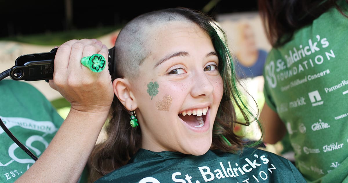 Young Girl Smiling While Getting Her Head Shaved For St. Baldricks