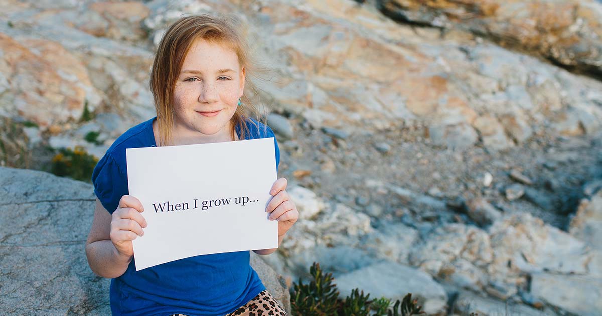 Photo of honored kid Grace holding a sign saying When I Grow Up