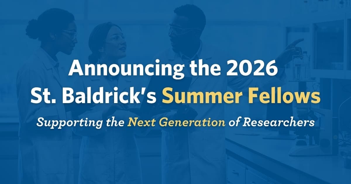 Announcing the 2026 St. Baldrick's Summer Fellows. Three researchers in lab coats discuss work in a lab, fostering collaboration and innovation.
