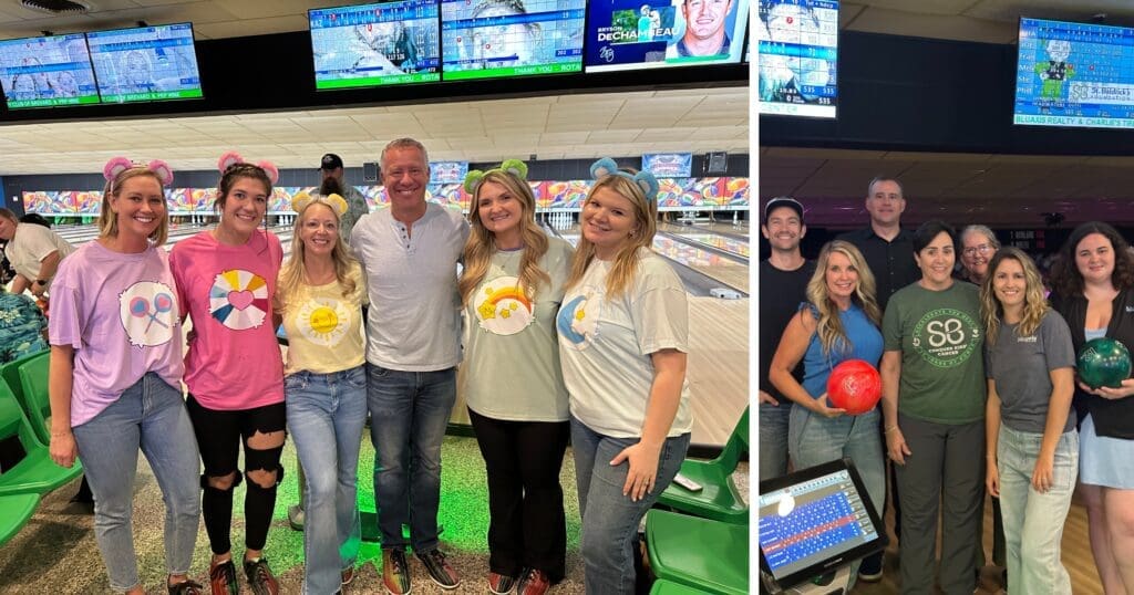 A group of people at a bowling alley, wearing colorful shirts and smiling. They're posing in front of bowling lanes with bowling balls visible. The atmosphere is cheerful and lively.
