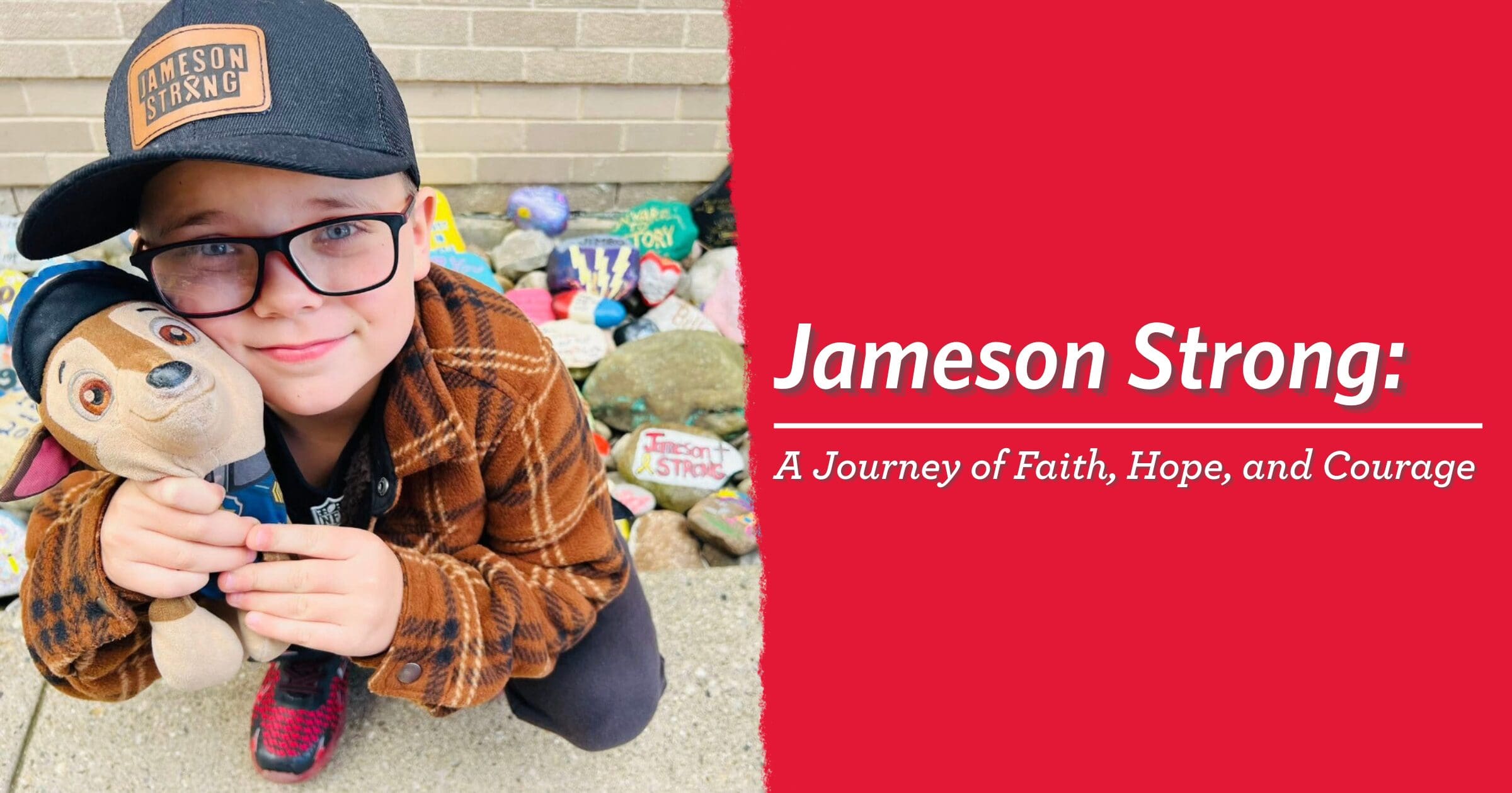 Young child in glasses and cap smiles, holding a plush toy. Behind, colorful painted rocks. Text: "Jameson Strong: A Journey of Faith, Hope, and Courage."